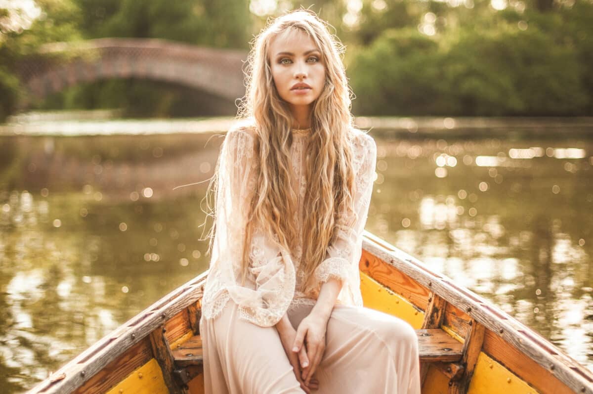 enchanting blond lady on a boat basking in the sun