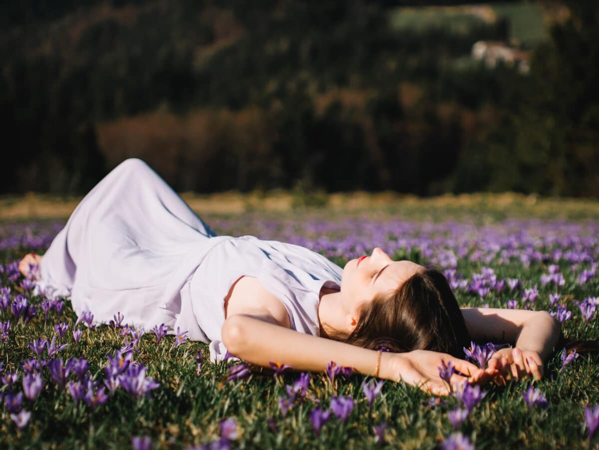 Beautiful girl in the flower field with crocuses
