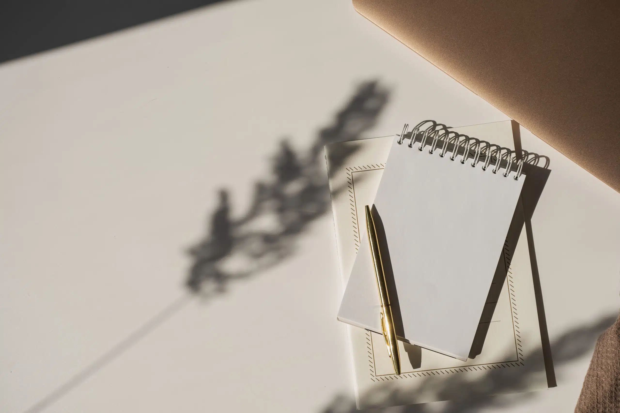 Blank paper sheet notebook with flower shadow.