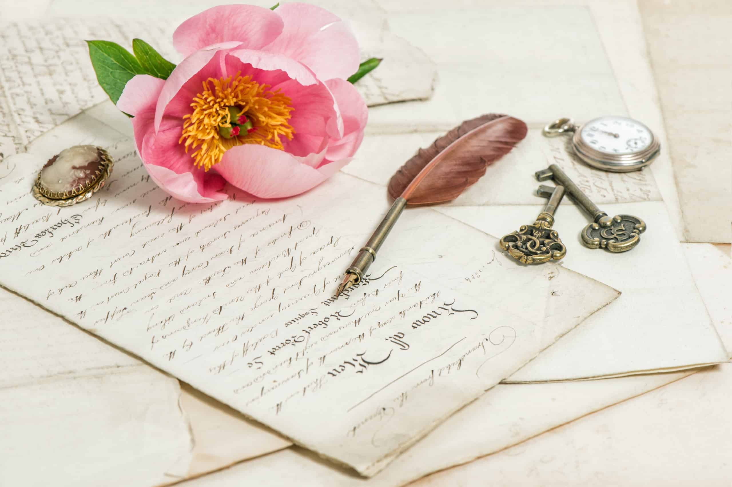 Old written works, vintage feather pen, keys, and pocket watch.