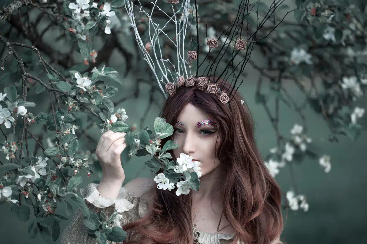 Fairy-tail forest nymph wearing crown, beautiful sexy woman at spring garden, vintage dreamy fashion style