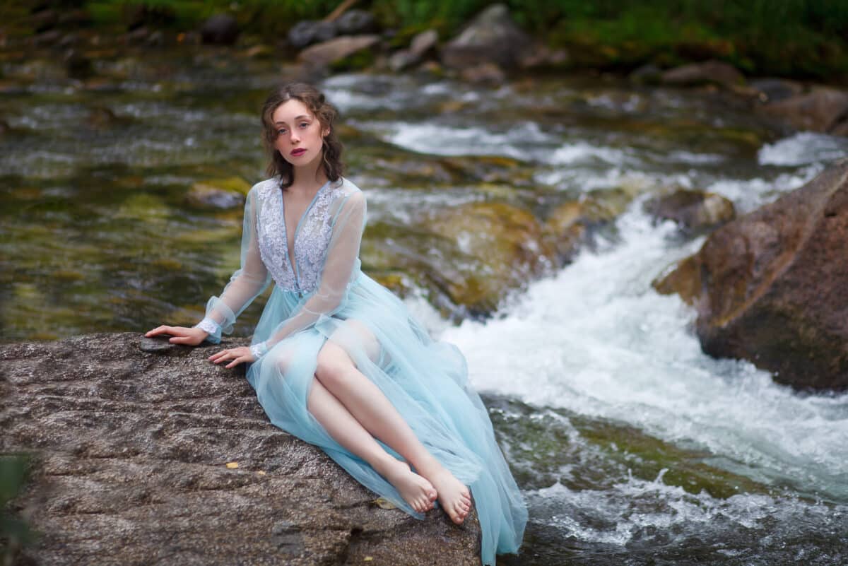 The Tale of the Mermaid. Tale of the River Nymph. Girl in a blue dress by the river.