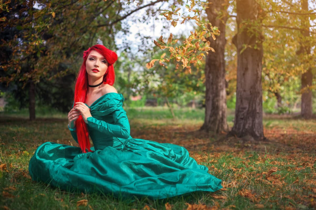 Cute girl in a beautiful dress in an autumn forest. Character of a mermaid at the cosplay festival