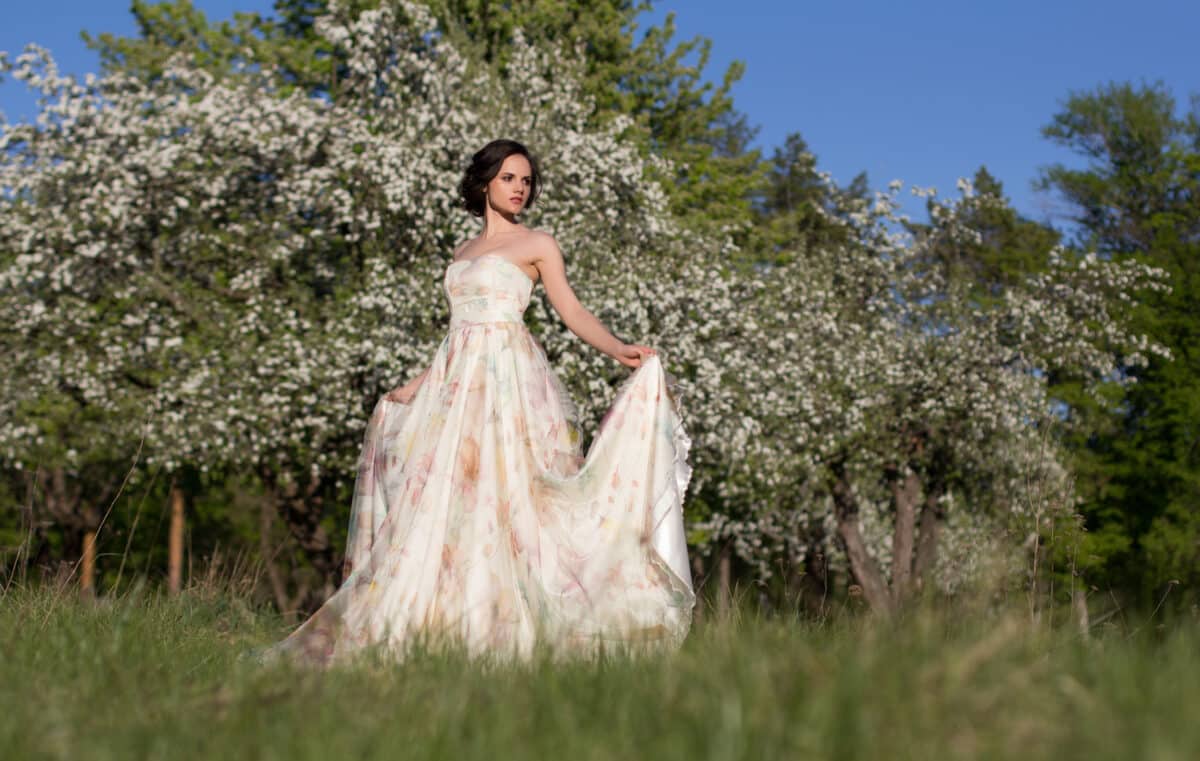 elegant lady in long dress, fairy tale, in blossom garden