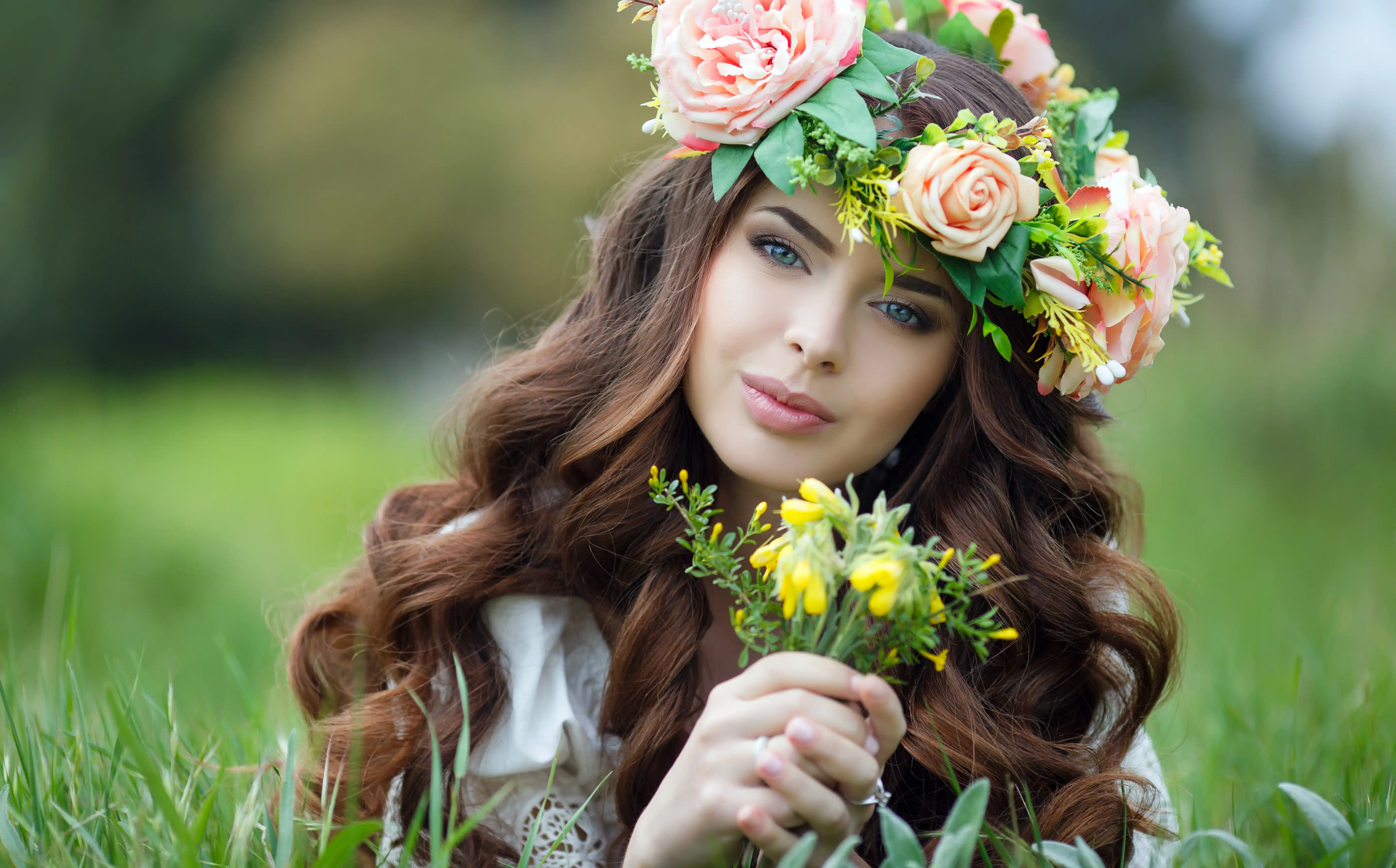 beautiful woman in wreath of flowers outdoor