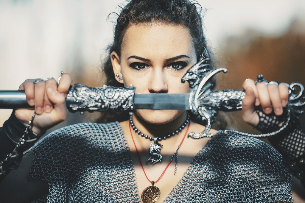 Stunning, fierce female knight with sword.