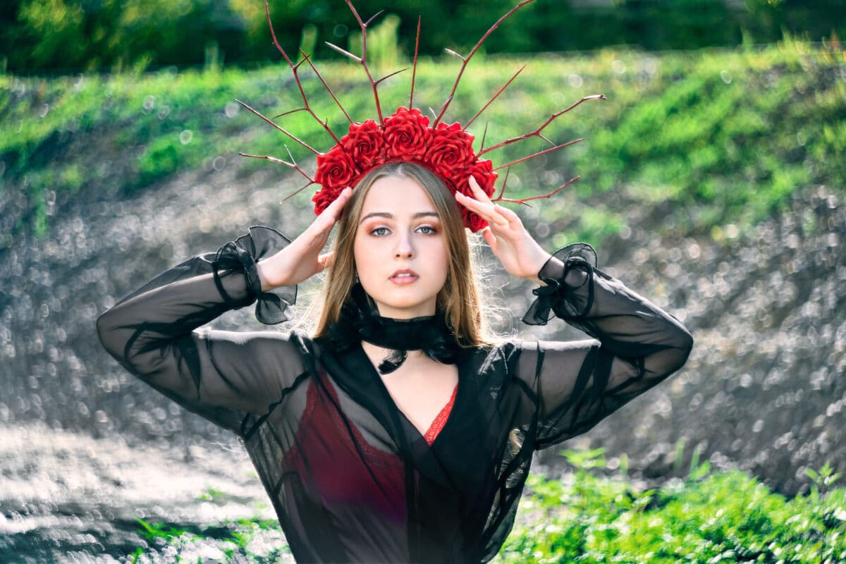 girl teenager princess with a crown in a red dress.