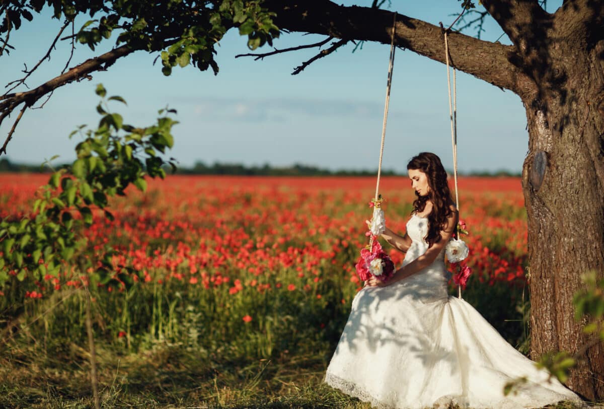 bride on a swing tied to a tree