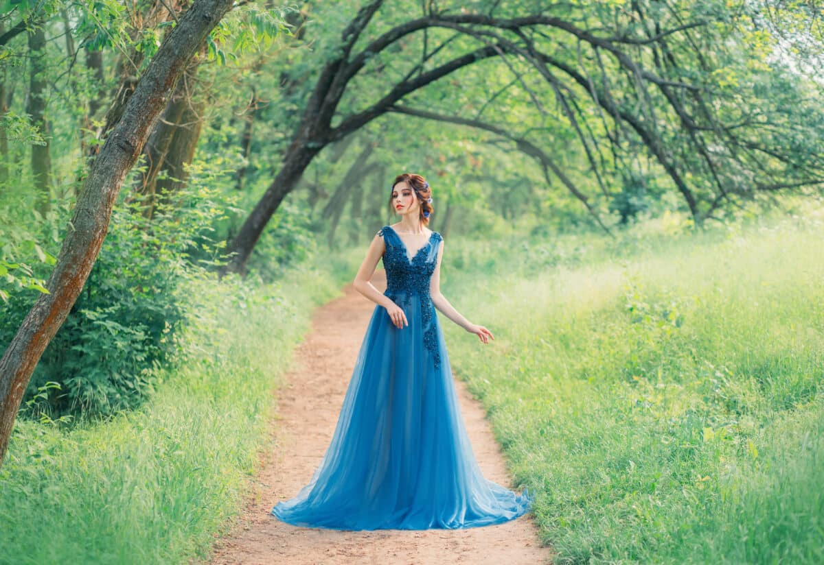 incredible cute sea princess walks through a red fairy forest alone, a magic fairy in a green turquoise dress, a cute dark-haired nymph like a magic flower, a lady on a secret path, creative colors