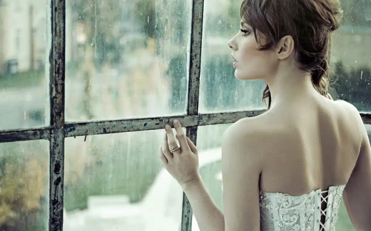 an enchanting beauty looking out the window waiting for someone
