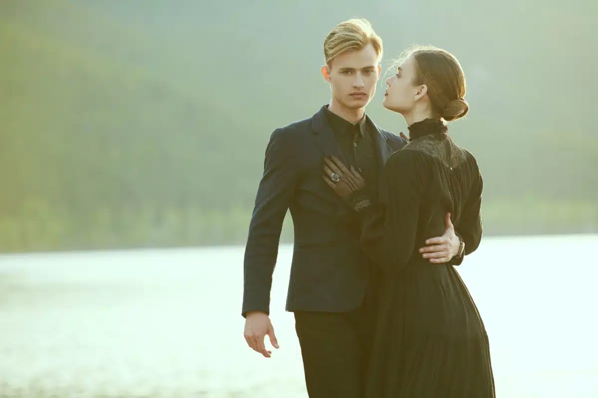 beautiful loving victorian couple hugging by the lake