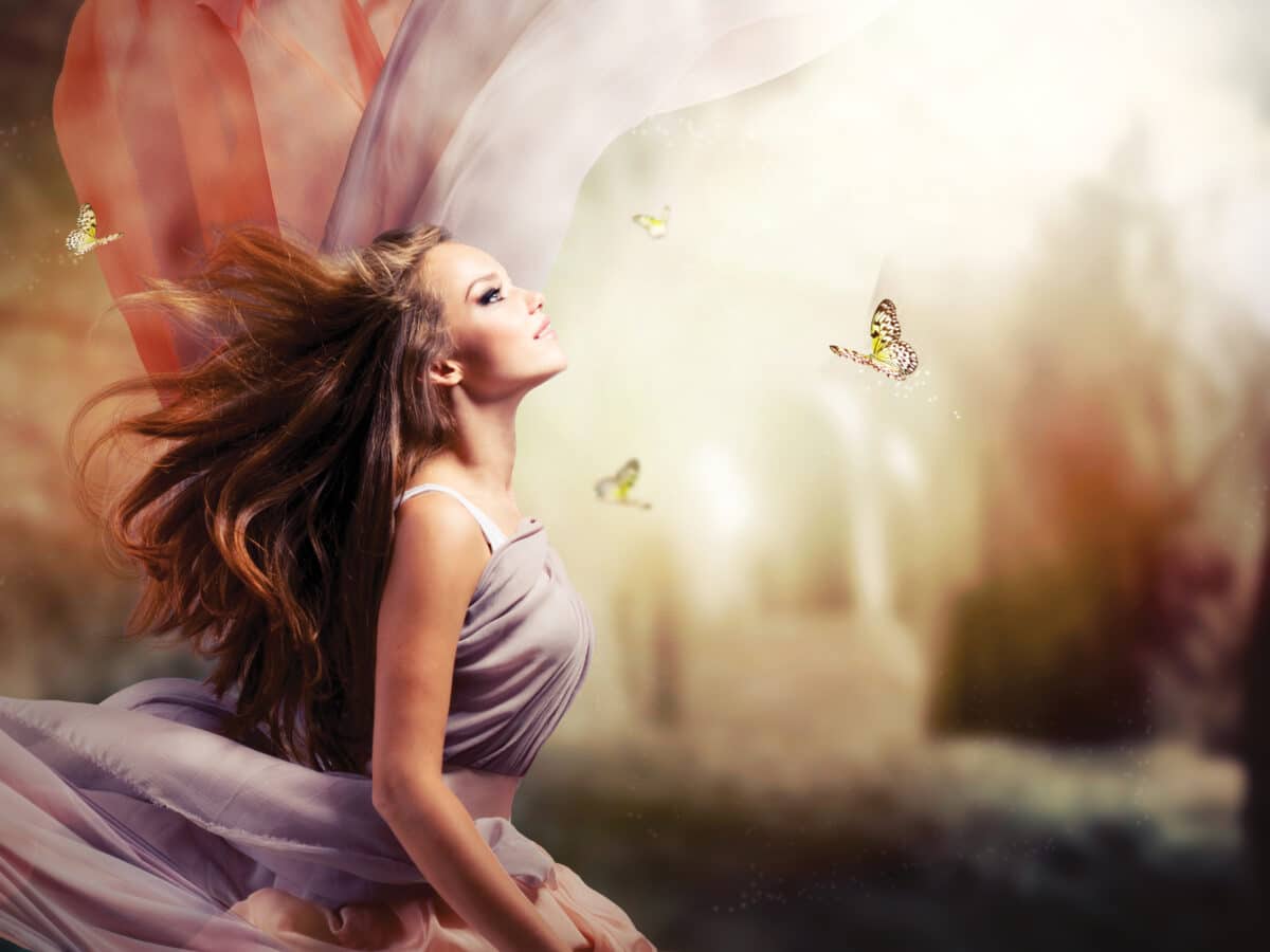 beautiful fantasy girl looking at the butterflies hovering around her
