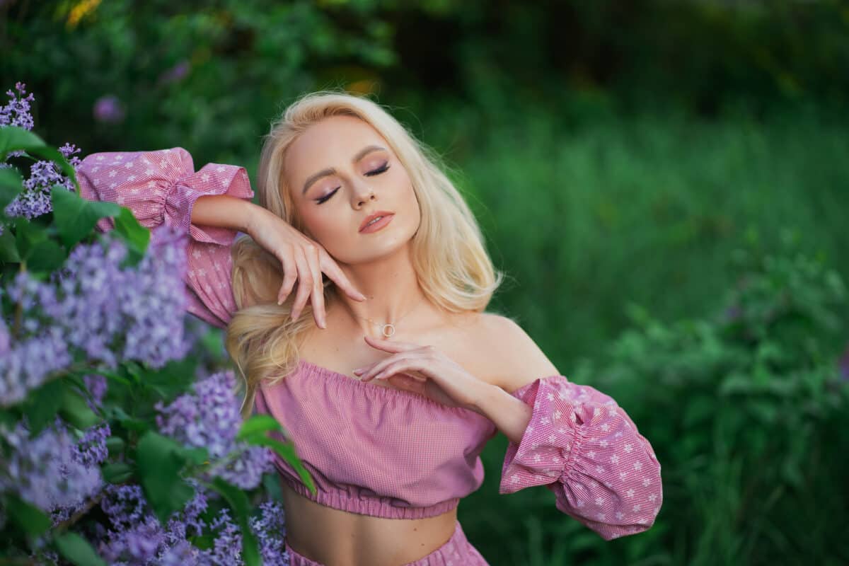 very beautiful girl in a pink top in purple flowers