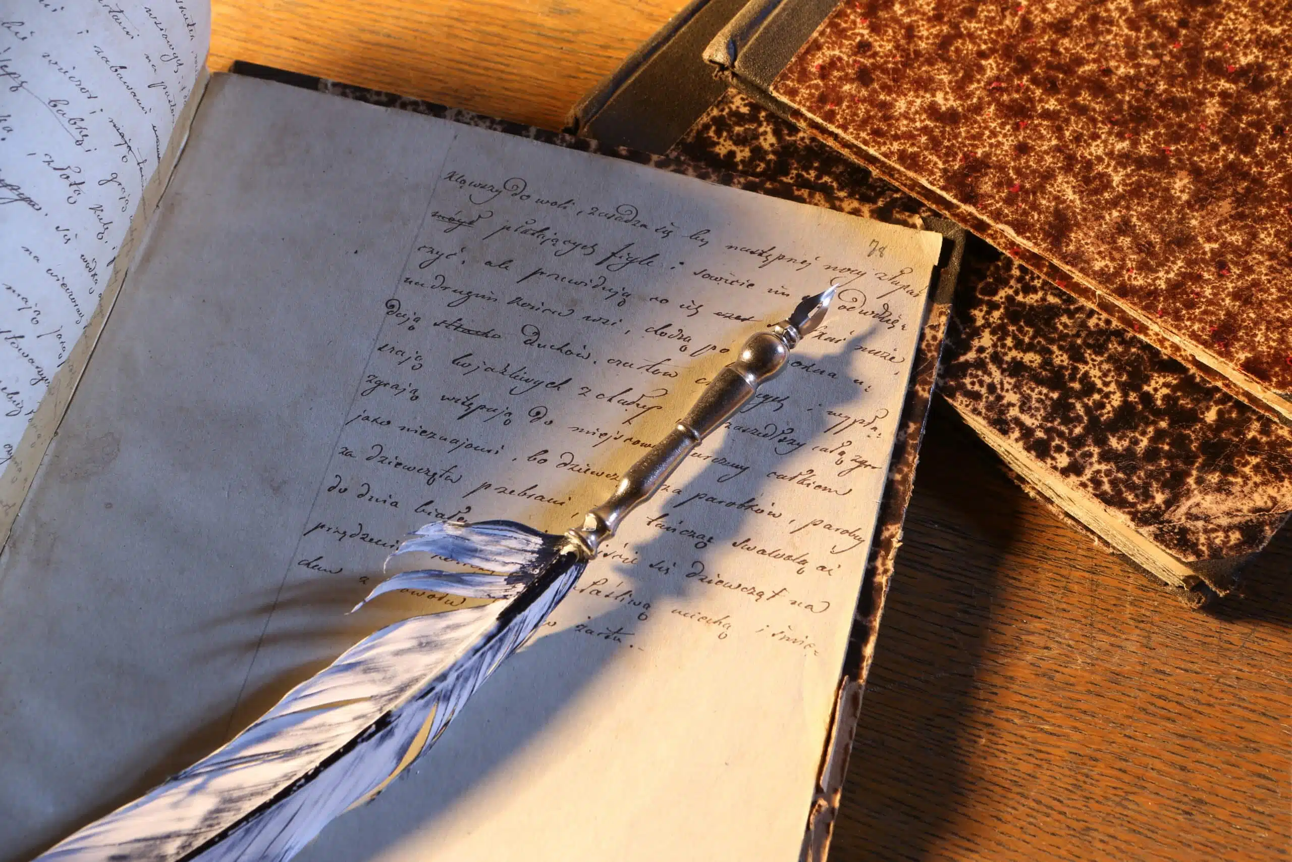 Silver quill pen on notebook.