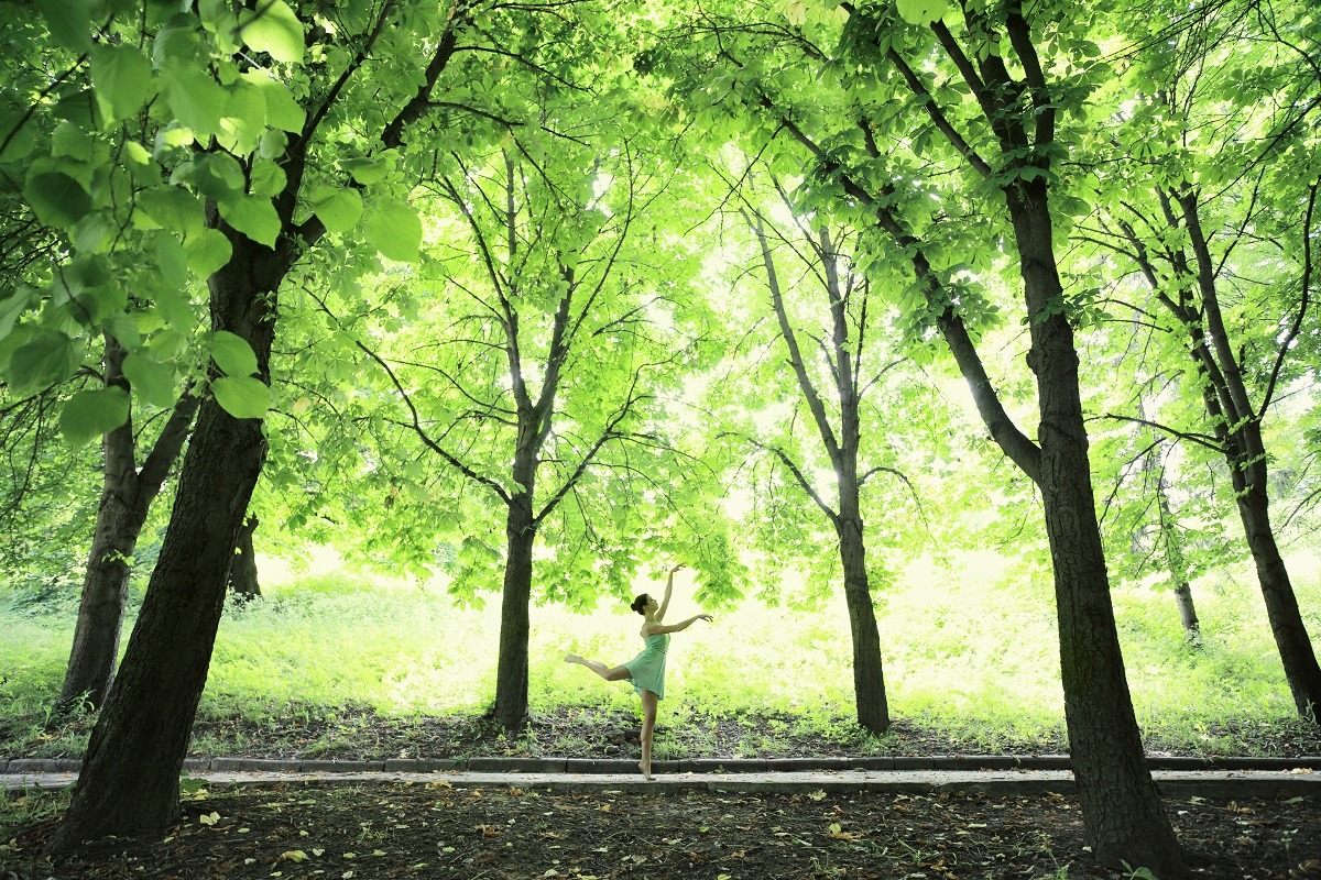 Young woman dancing ballet in the spring forest.