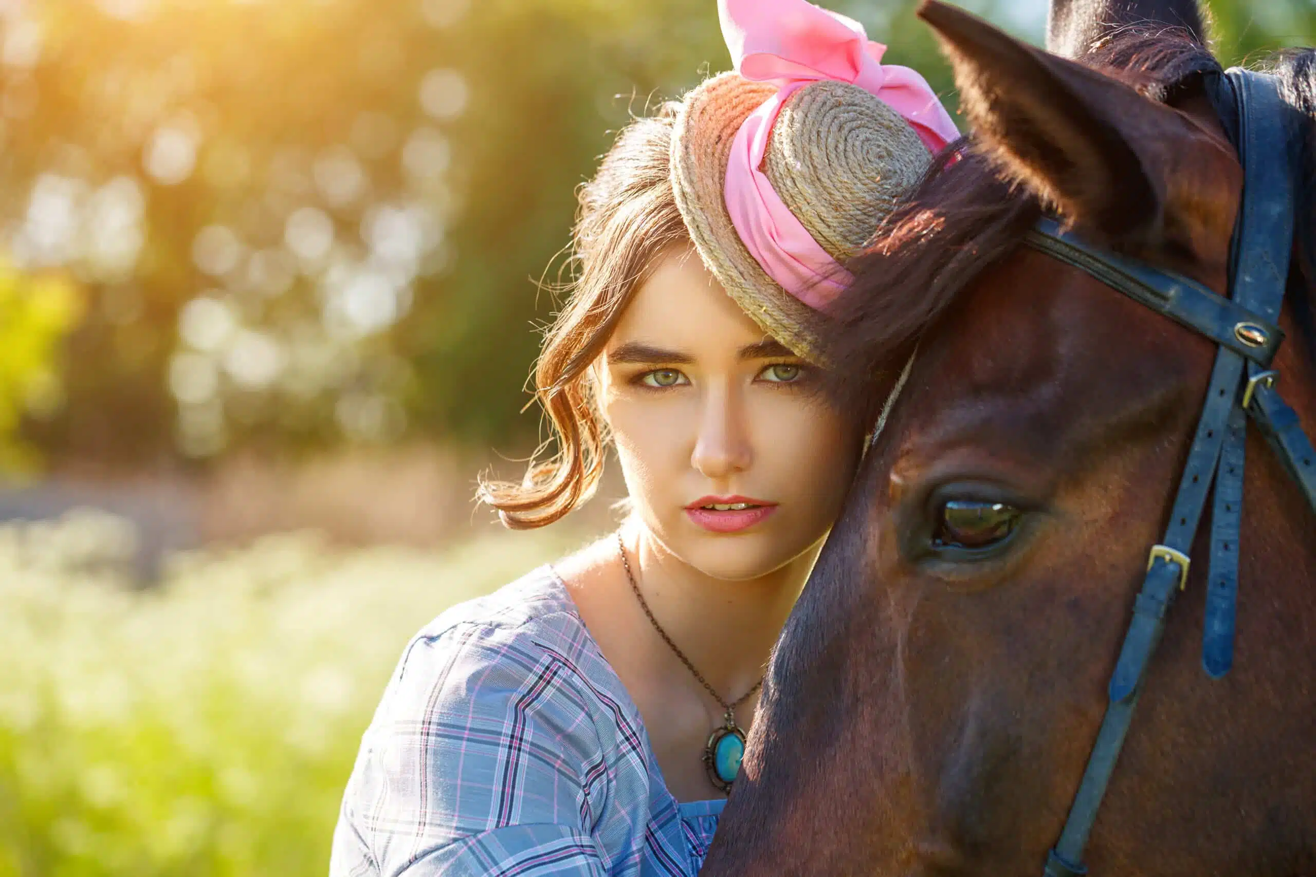 a beautiful young woman with a horse