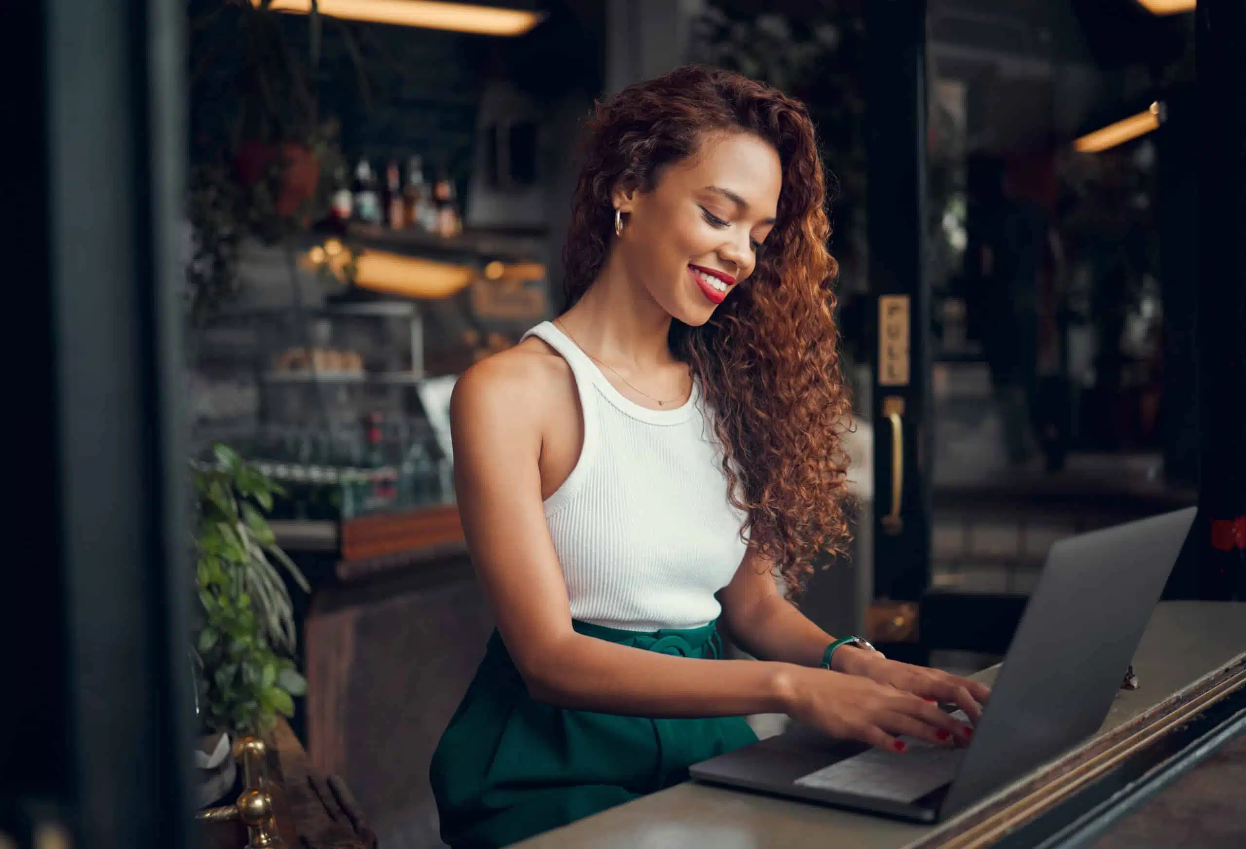 young redhead female writer working at a coffee shop