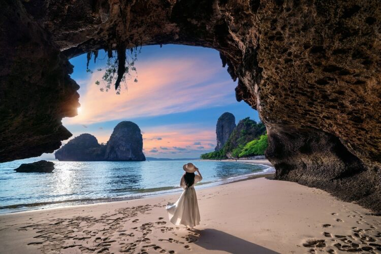 Woman walking on Railay beach, Krabi in Thailand.