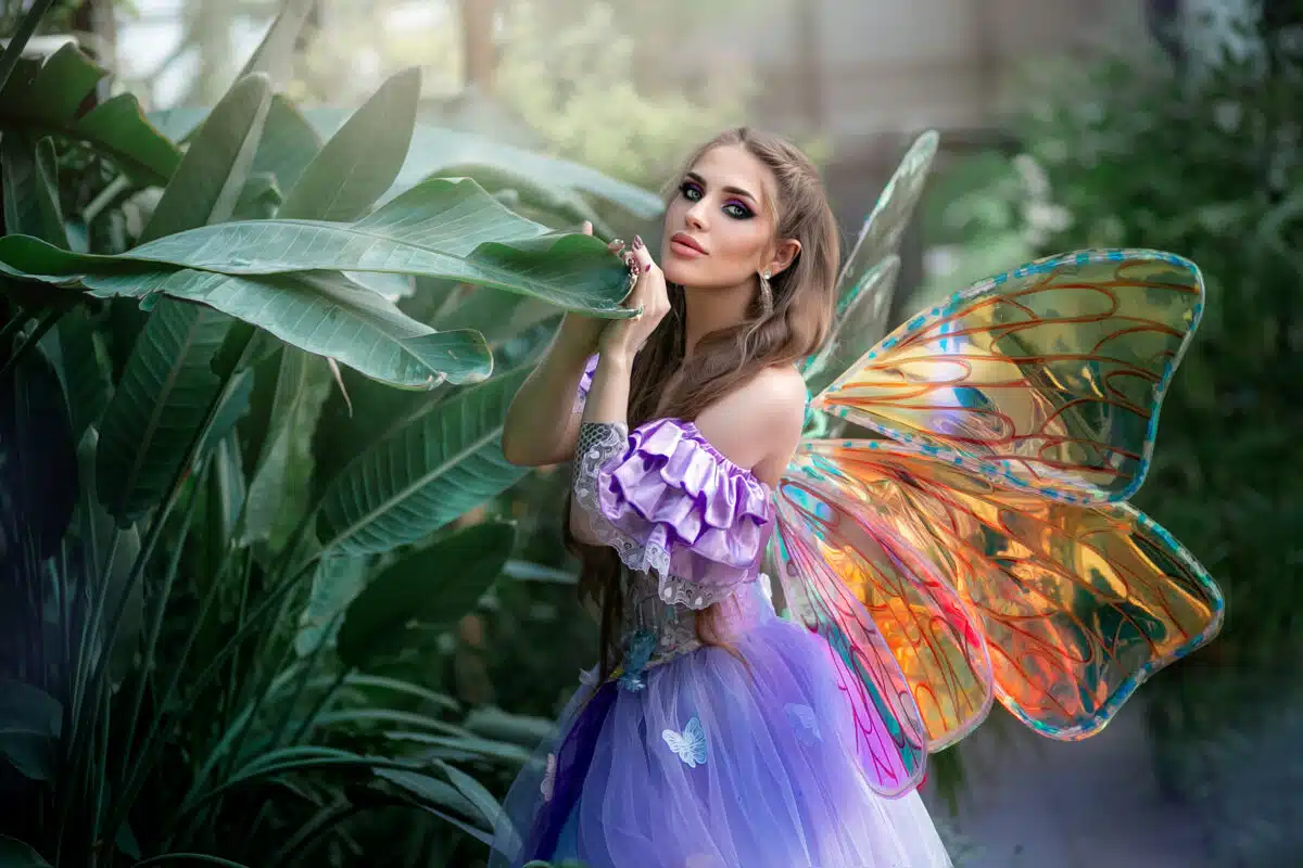 A beautiful woman is a little cute fairy with butterfly wings in