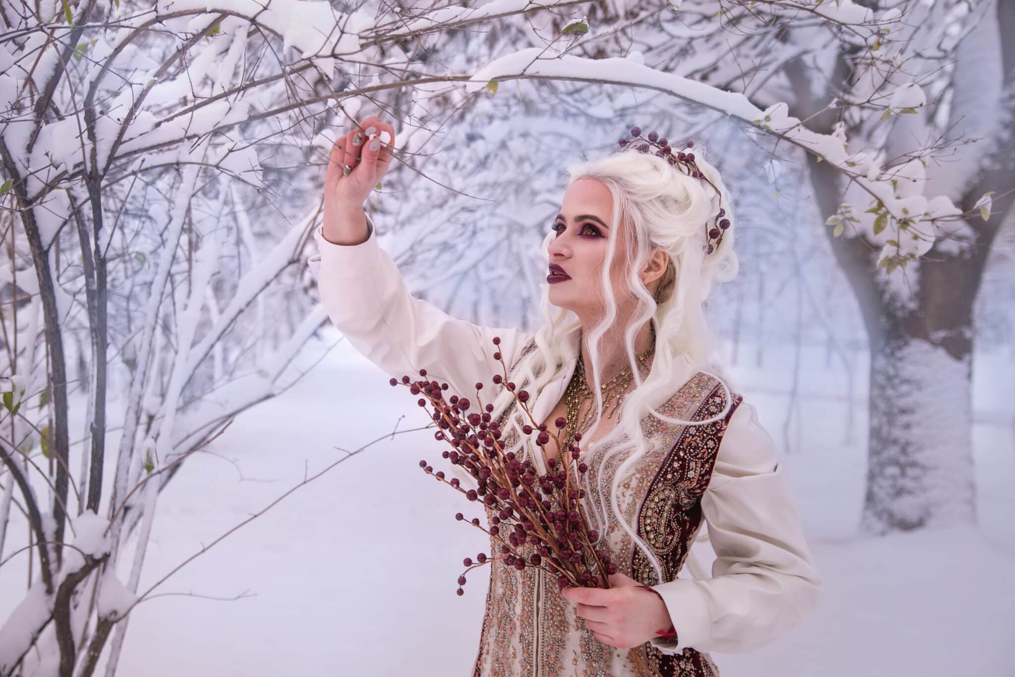 A beautiful girl in a princess costume walks through the winter