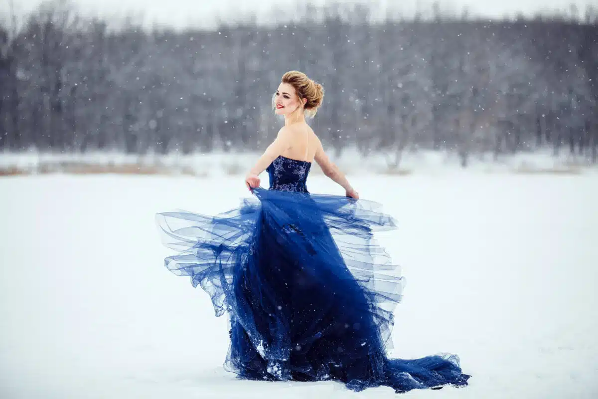 princess in blue gown enjoying the snow