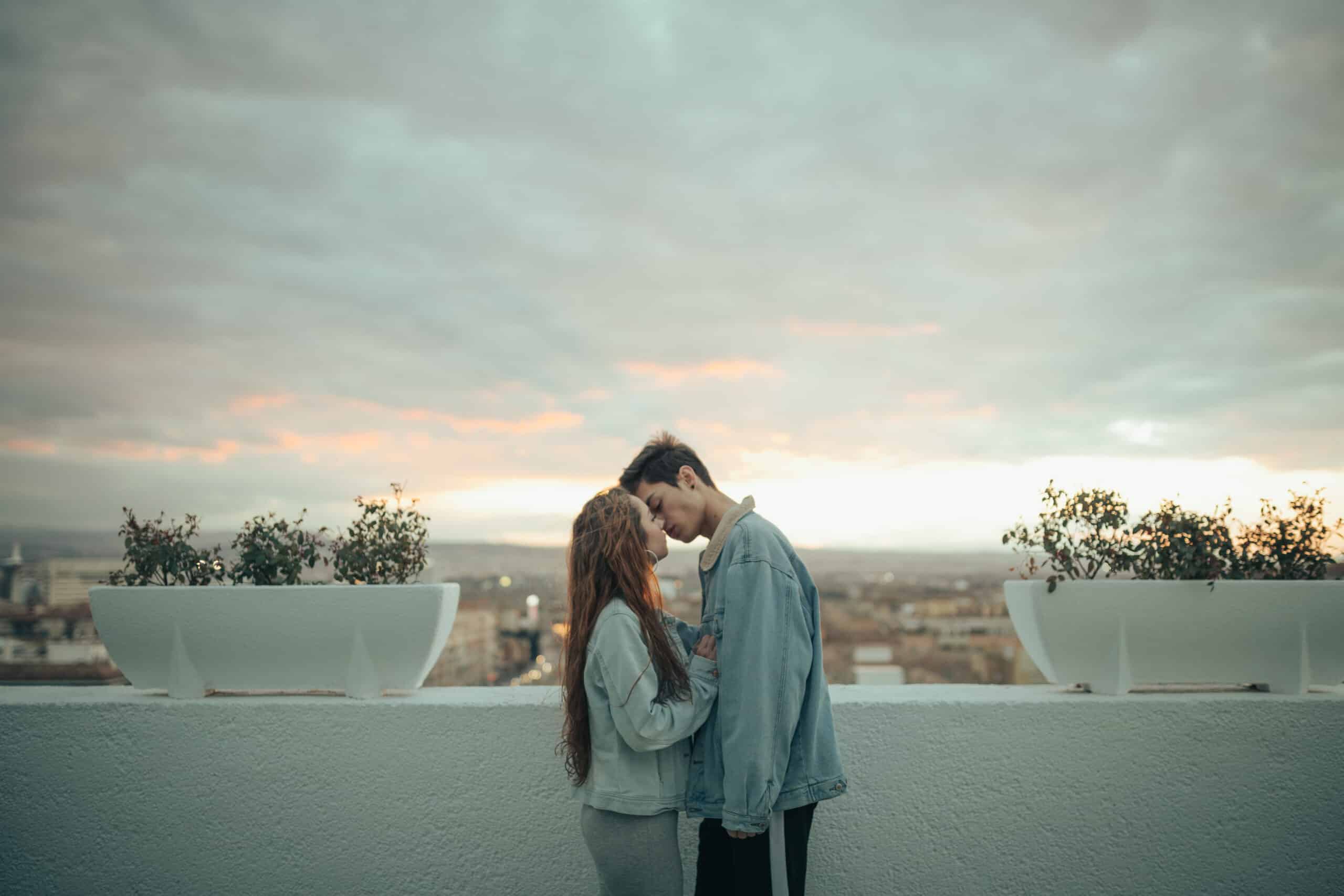Young lovers kissing in a beautiful sunset