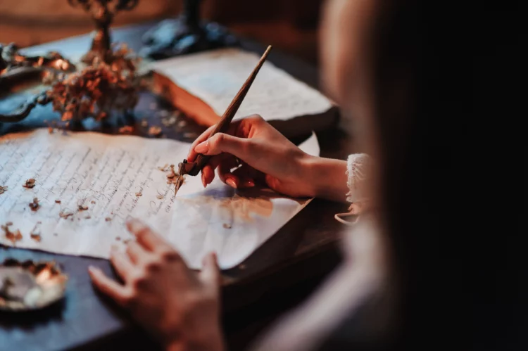 Woman writes a letter with an antique fountain pen.